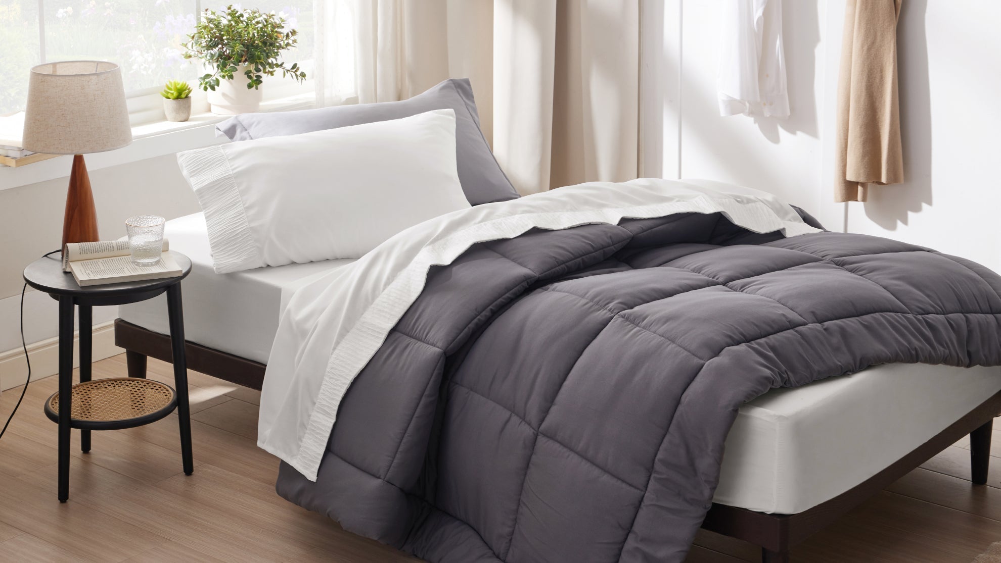 A cozy, well-lit small bedroom featuring a space-saving bed dressed in minimalist, light-colored cotton bedding, demonstrating how proper sizing and neutral tones make compact spaces feel airy and larger.