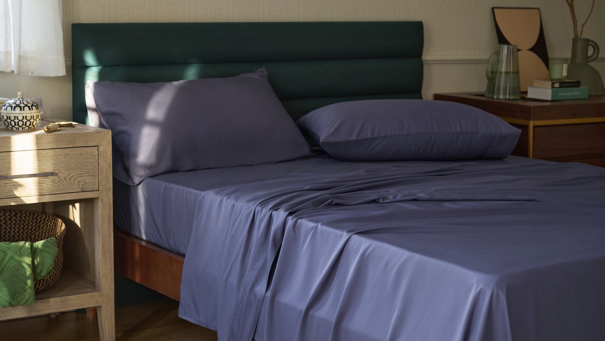 Blue bamboo sheets on a styled bed with pillows