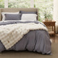 Plush white blanket with textured pattern on gray rayon bamboo bedding.