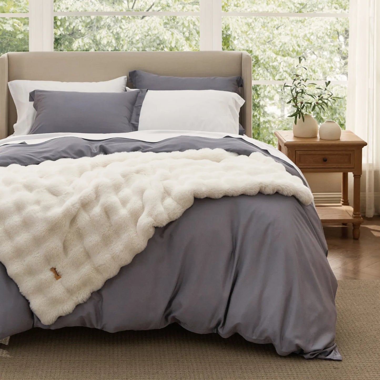 Plush white blanket with textured pattern on gray rayon bamboo bedding.