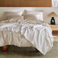 Organic Cotton Waffle Serenity Bundle: White waffle blanket on neutral organic cotton bedding.
