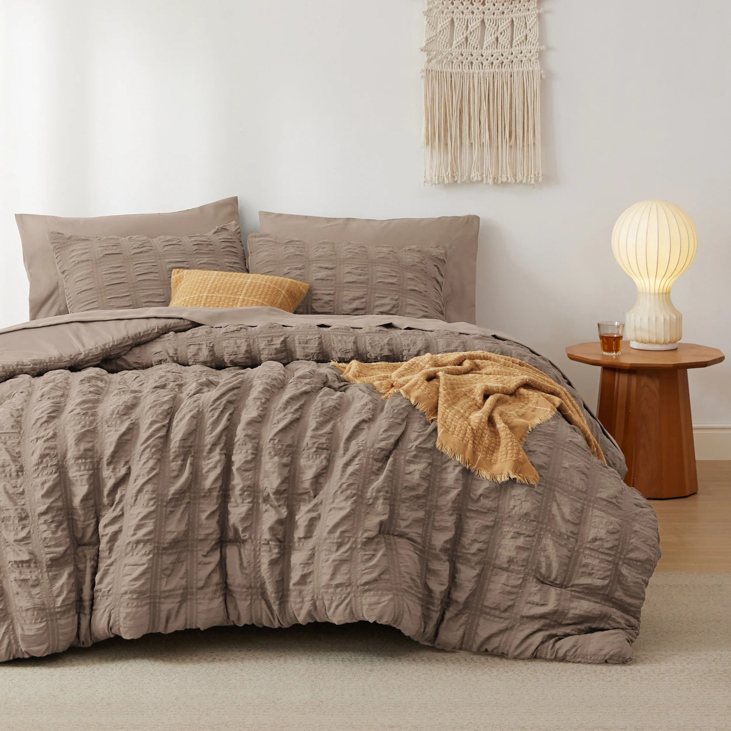 Cozy taupe seersucker bed-in-a-bag set featuring textured plaid comforter and pillows.