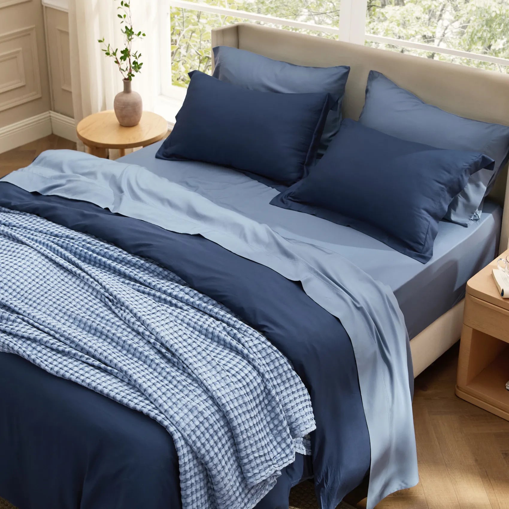 Rayon bamboo bedding set in navy and light blue, with a blue textured waffle blanket.