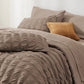 Seersucker Bed-in-a-Bag set in taupe, featuring textured comforter and decorative plaid pillow.