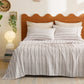 Soft cotton-like striped sheet set with thin charcoal vertical stripes on a bed.