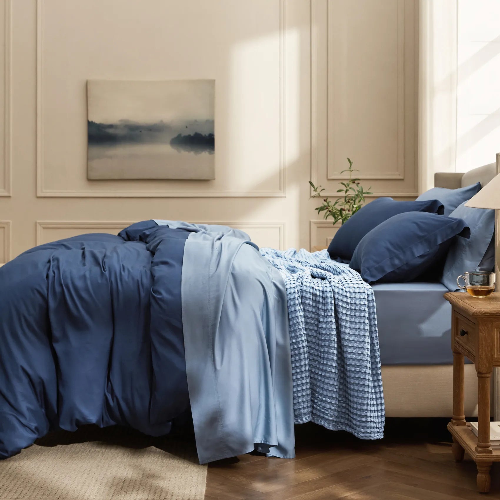 Blue rayon derived from bamboo bedding bundle with textured waffle blanket.