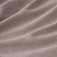 Textured cationic dyed polyester fabric from comforter set, dual-tone beige.