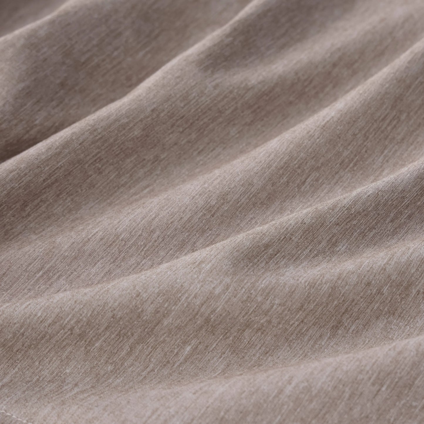 Textured cationic dyed polyester fabric from comforter set, dual-tone beige.