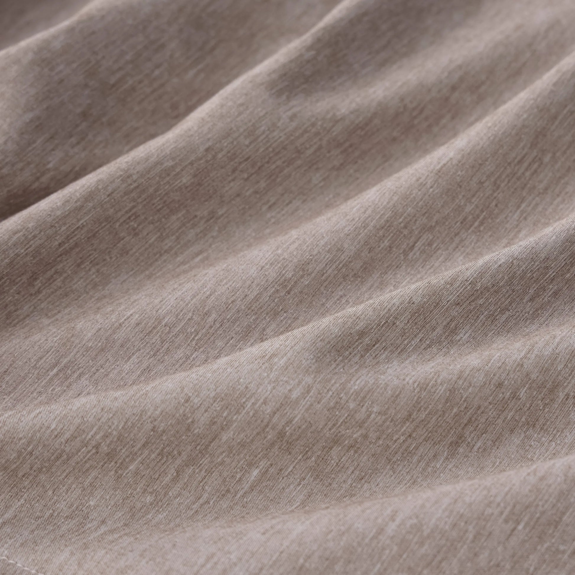 Textured cationic dyed polyester fabric from comforter set, dual-tone beige.