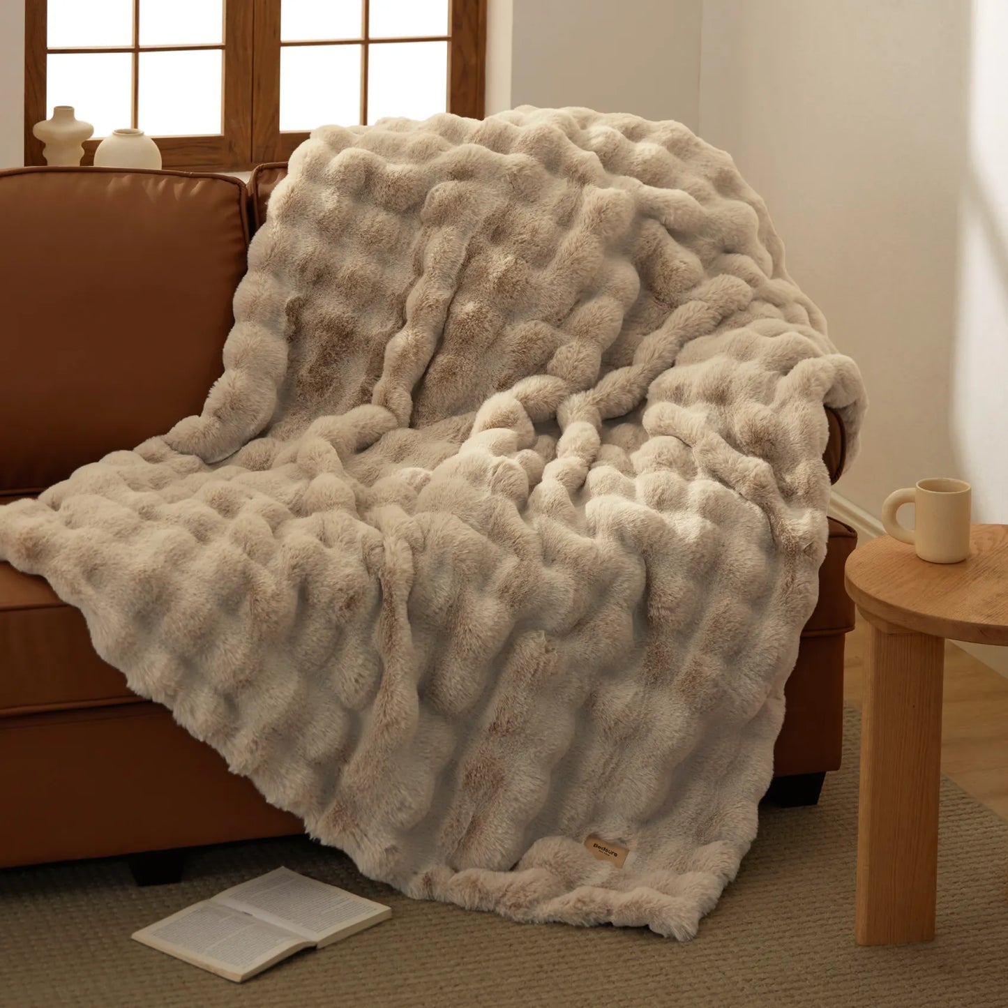 Bedsure luxe plush blanket with ripple texture in warm beige, on sofa.
