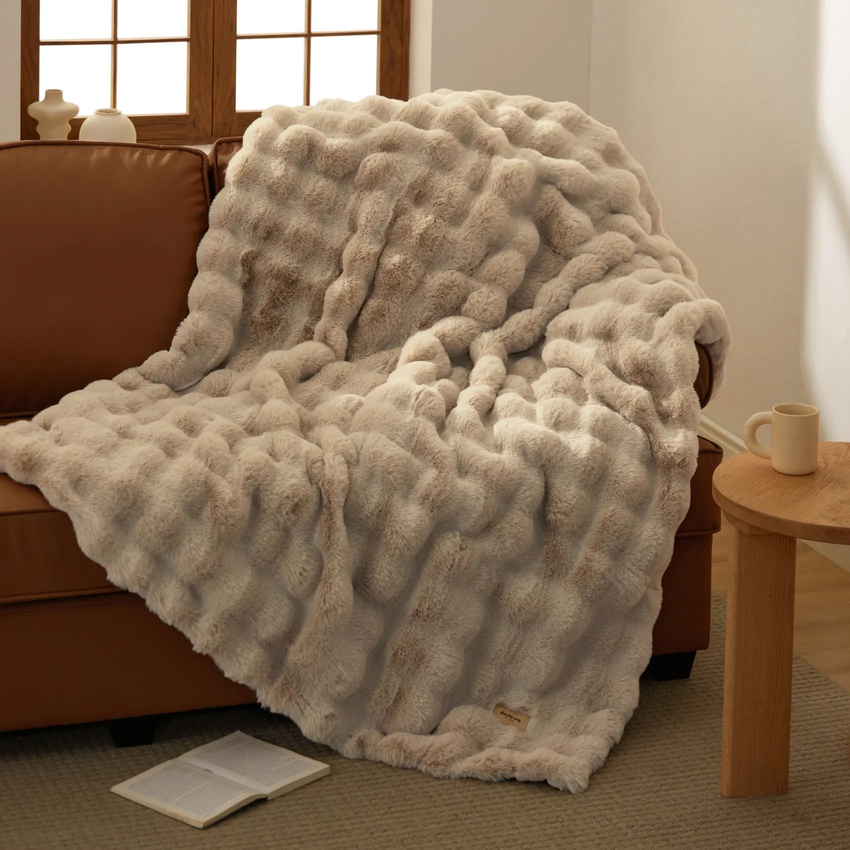 Bedsure luxe plush blanket with ripple texture in warm beige, on sofa.