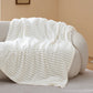 White plush polyester blanket with ribbed texture for a modern cozy bundle.