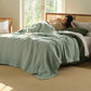 PureWoven™ light green 8-layer cotton gauze blanket with diamond quilt pattern.