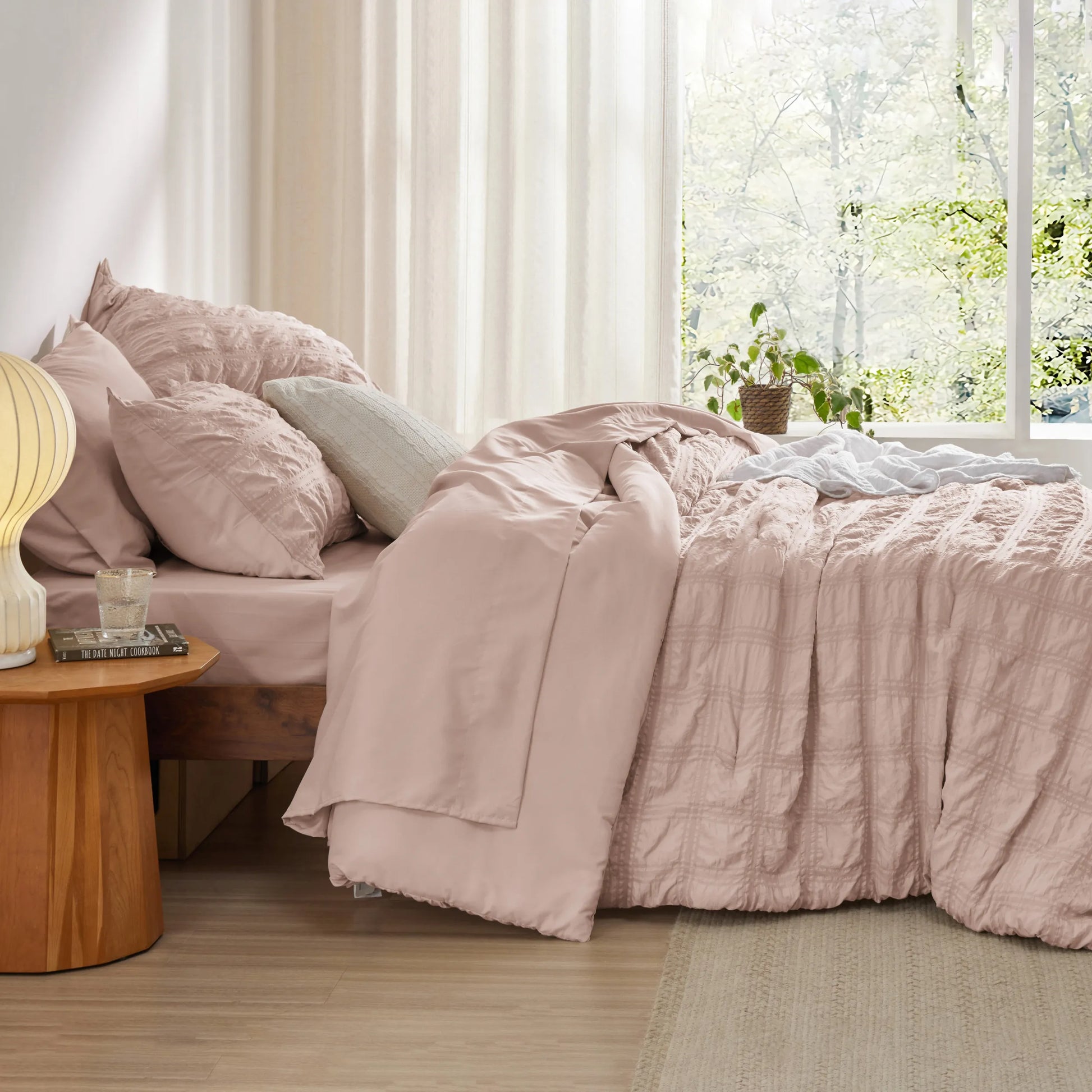Dusty rose seersucker plaid bed-in-a-bag set with textured comforter and pillow shams.