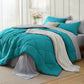 Turquoise quilted reversible bed-in-a-bag set with pillows and white textured throw.