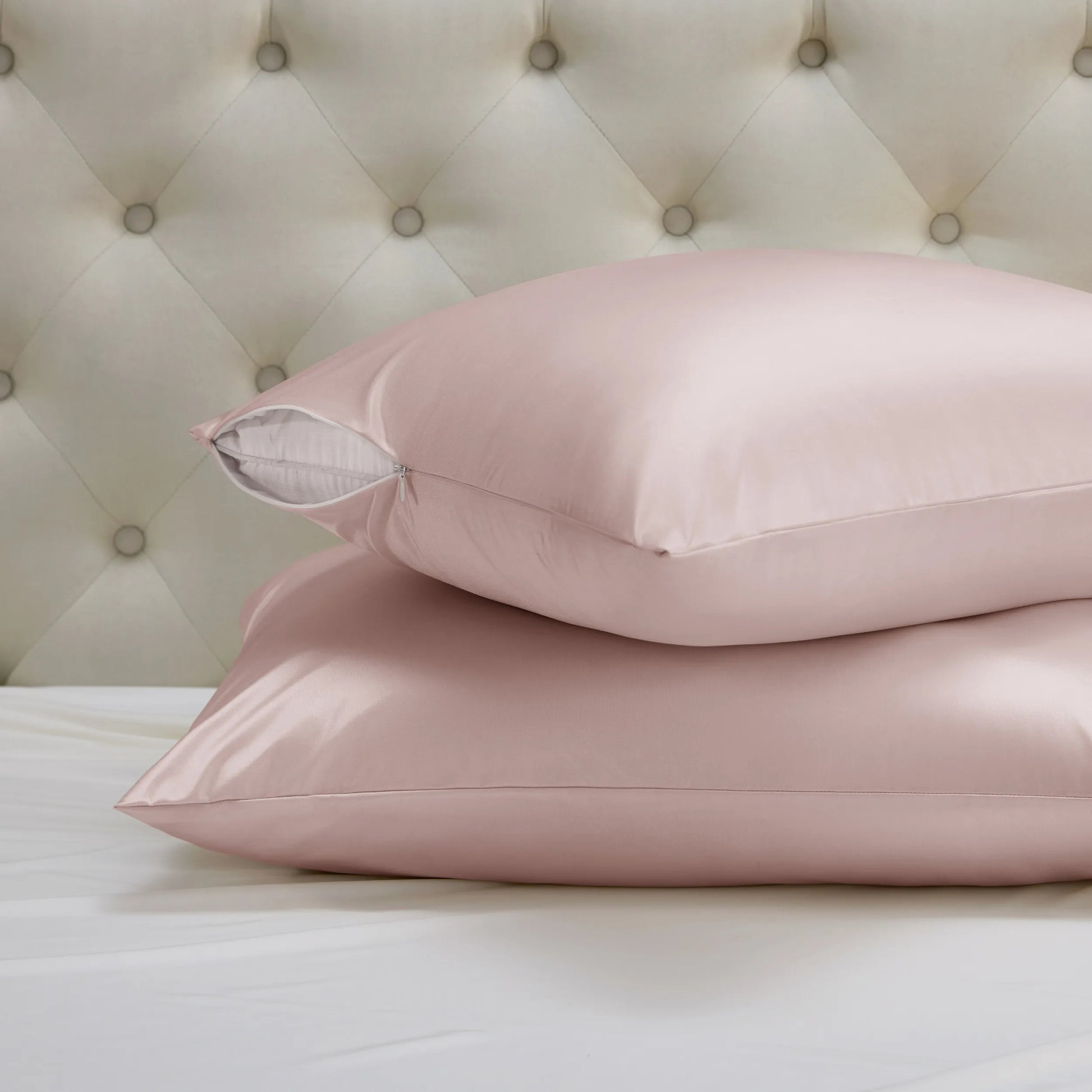 Two blush pink nylon-spandex beauty sleep pillowcases with hidden zipper closure.