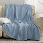 Soft blue waffle weave rayon derived from bamboo blanket on sofa.