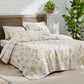 Botanical Quilt Set featuring a cream base with a delicate multicolor wildflower print and quilted texture.