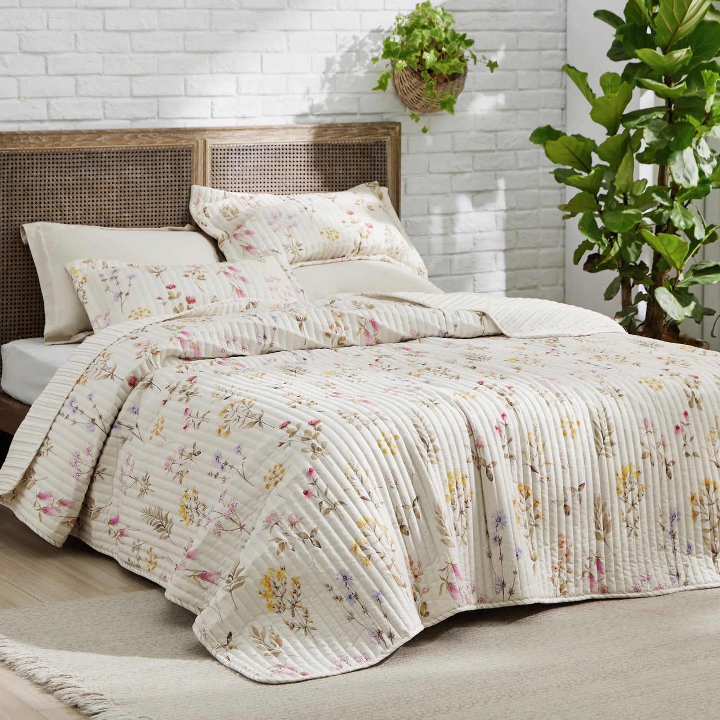 Botanical Quilt Set featuring a cream base with a delicate multicolor wildflower print and quilted texture.