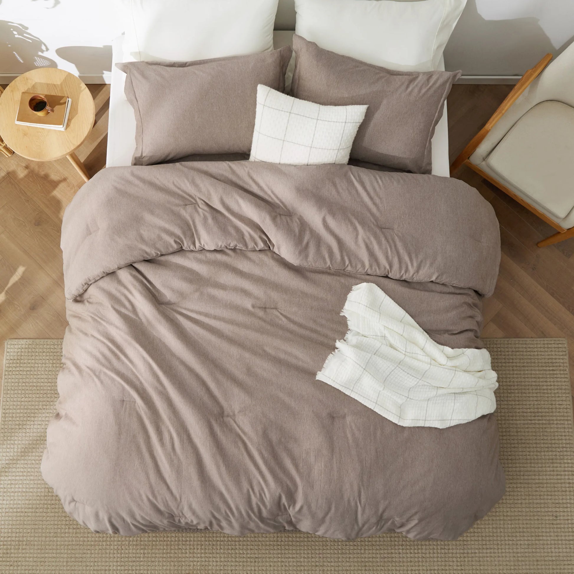 Dual-tone taupe cationic dye comforter set with shams on bed.
