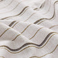 Light beige cotton-like striped sheet fabric with wavy dark stripes and textured weave.