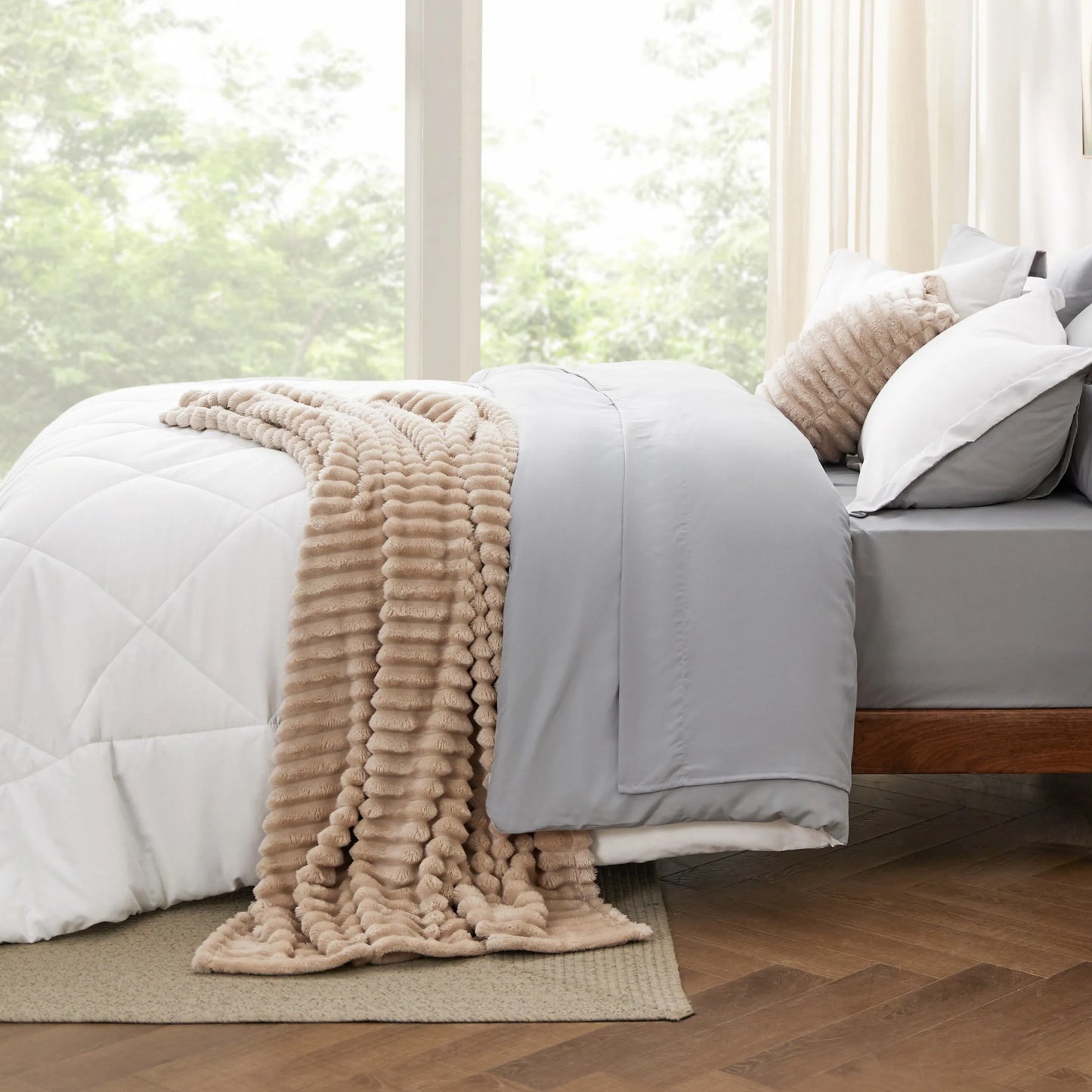Reversible Bed-in-a-Bag: white comforter, grey sheets, textured beige throw.