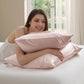 Pink Beauty Sleep pillowcases with cooling, skincare, and hair protection benefits, with woman relaxing.