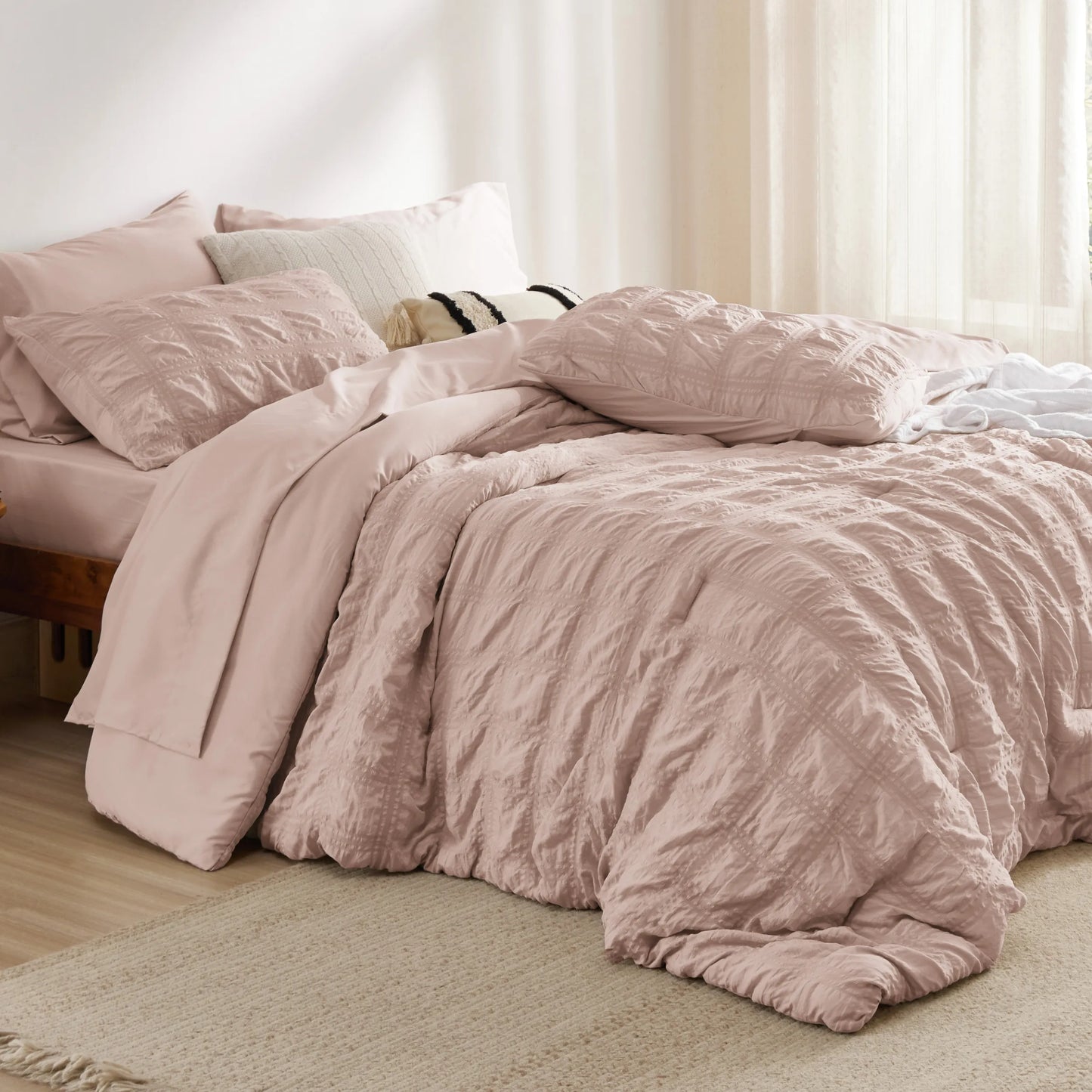 Blush pink seersucker bed-in-a-bag with diamond-stitched comforter & shams.