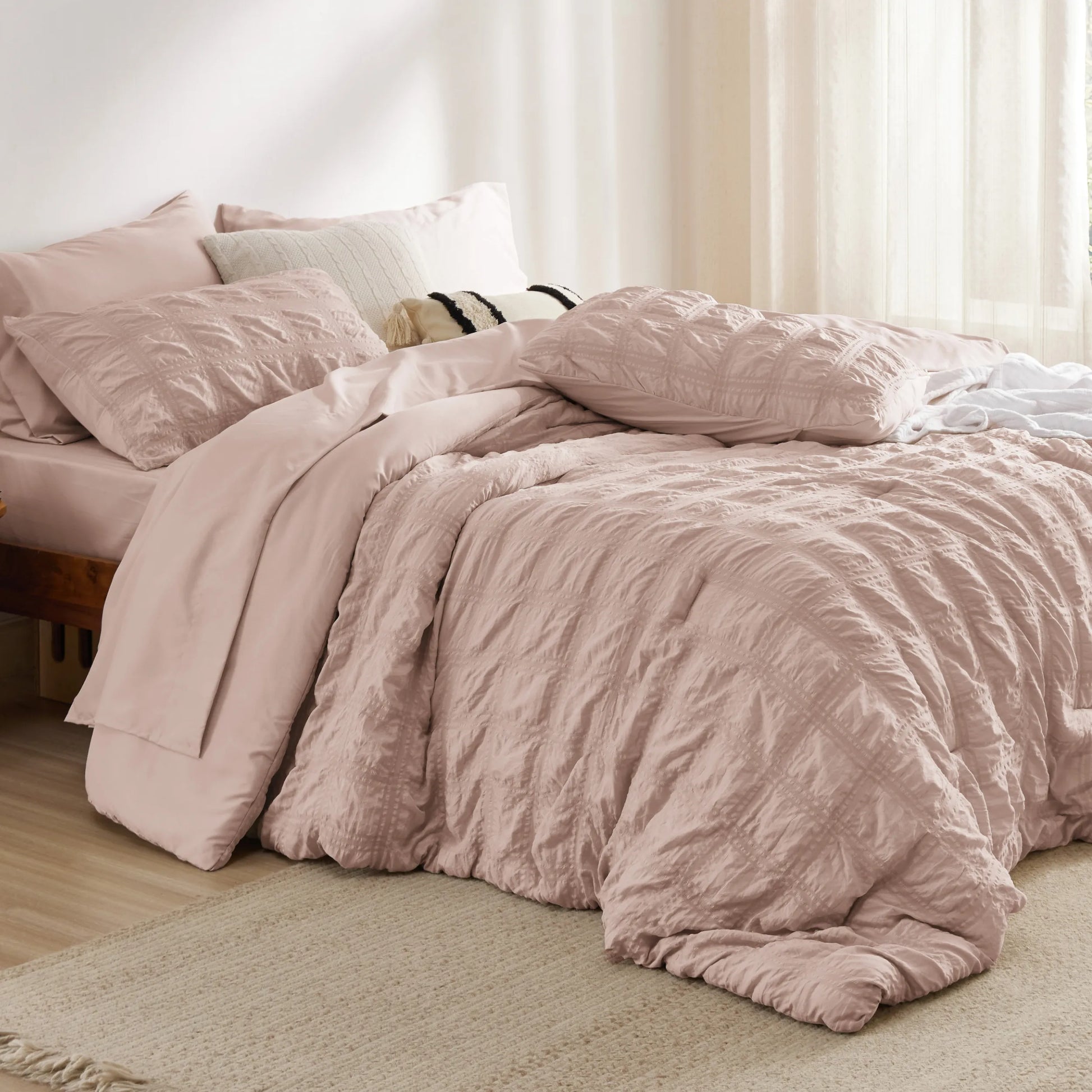 Blush pink seersucker bed-in-a-bag with diamond-stitched comforter & shams.