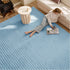 Soft blue polyester bubble flannel area rug with raised bubble texture.