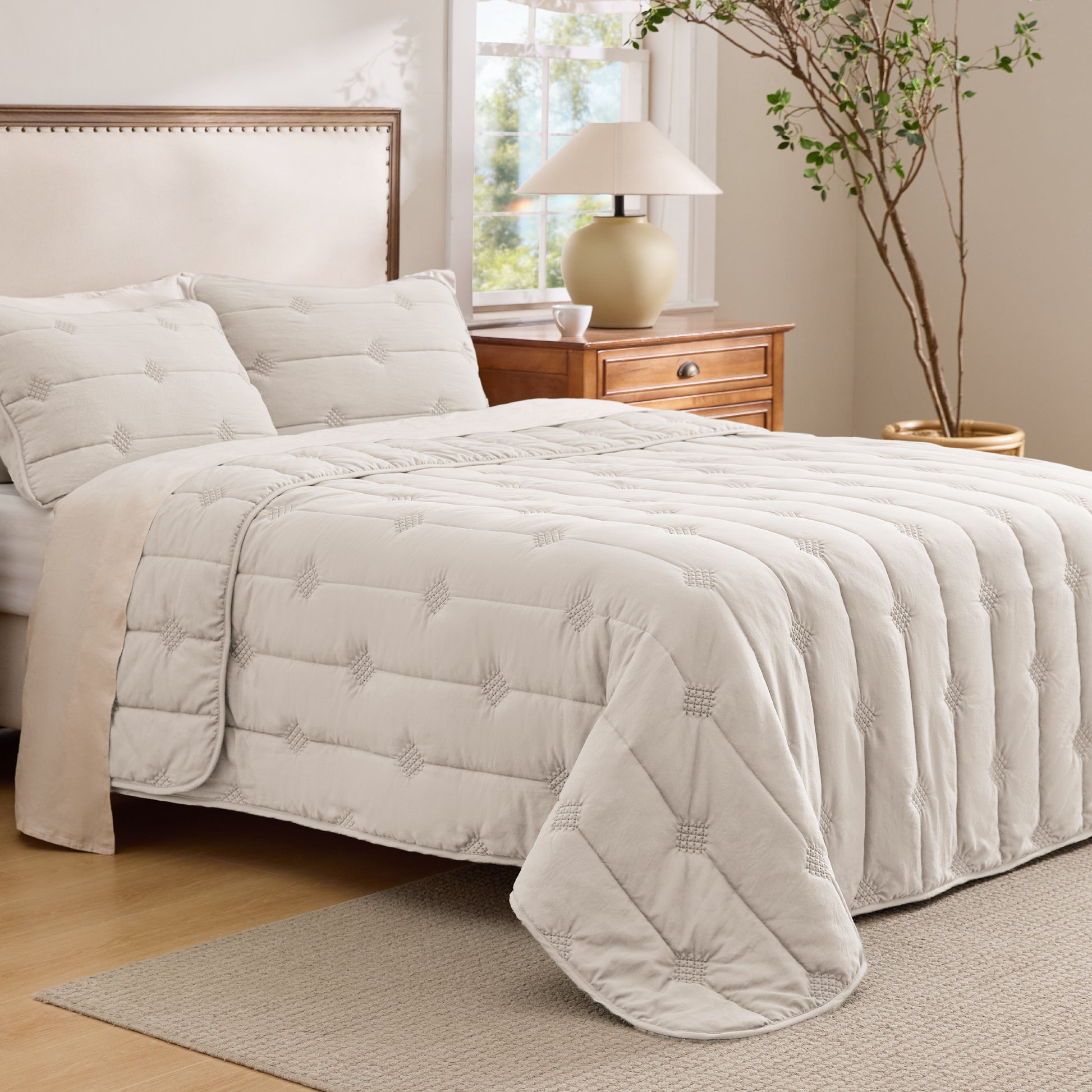 Cream prewashed diamond quilt set with vintage dot stitching and matching shams.