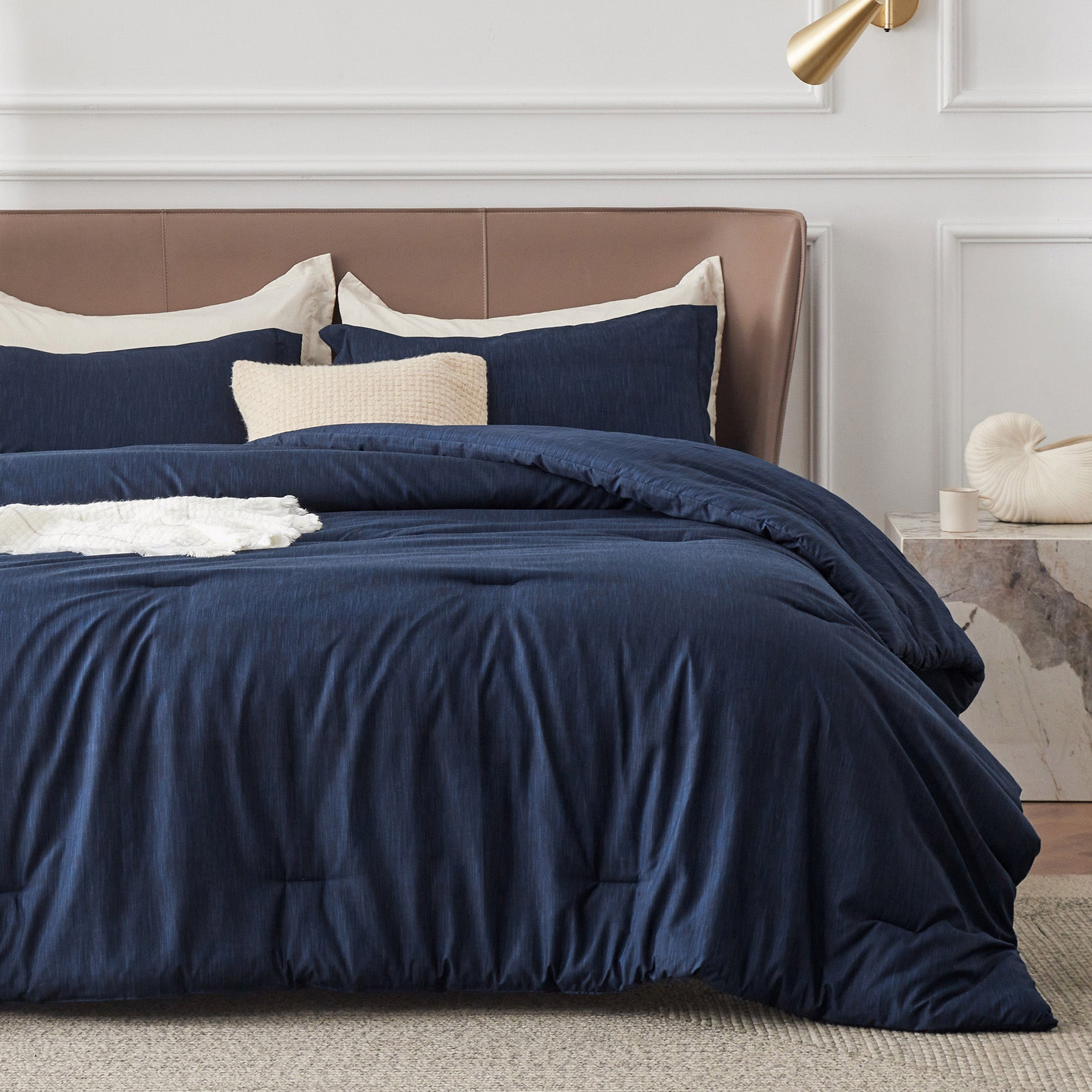 Navy blue GentleSoft comforter set with dual-tone texture on a bed, includes two pillow shams and decorative pillows.