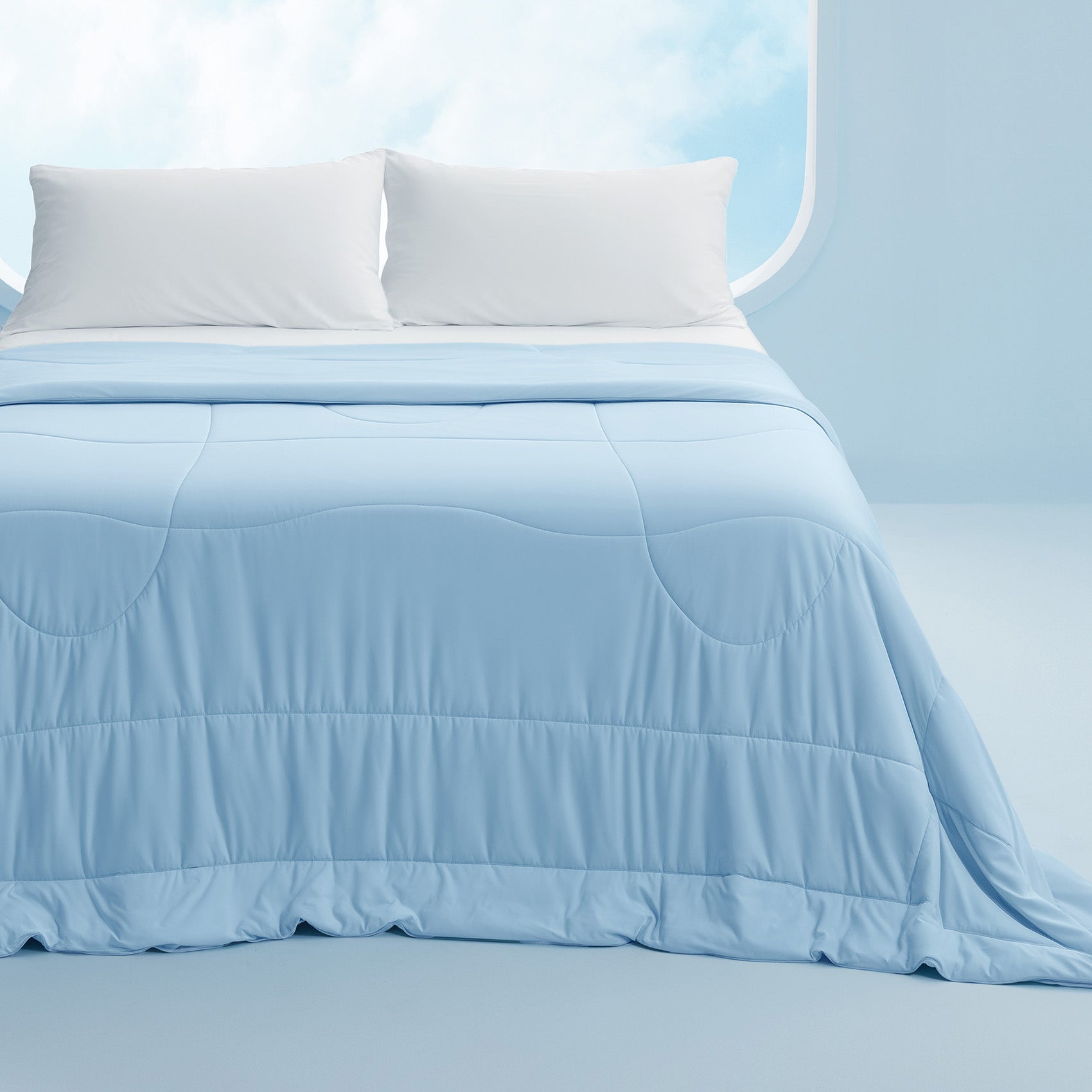 Light blue reversible cooling comforter featuring silky soft texture and a quilted pattern.