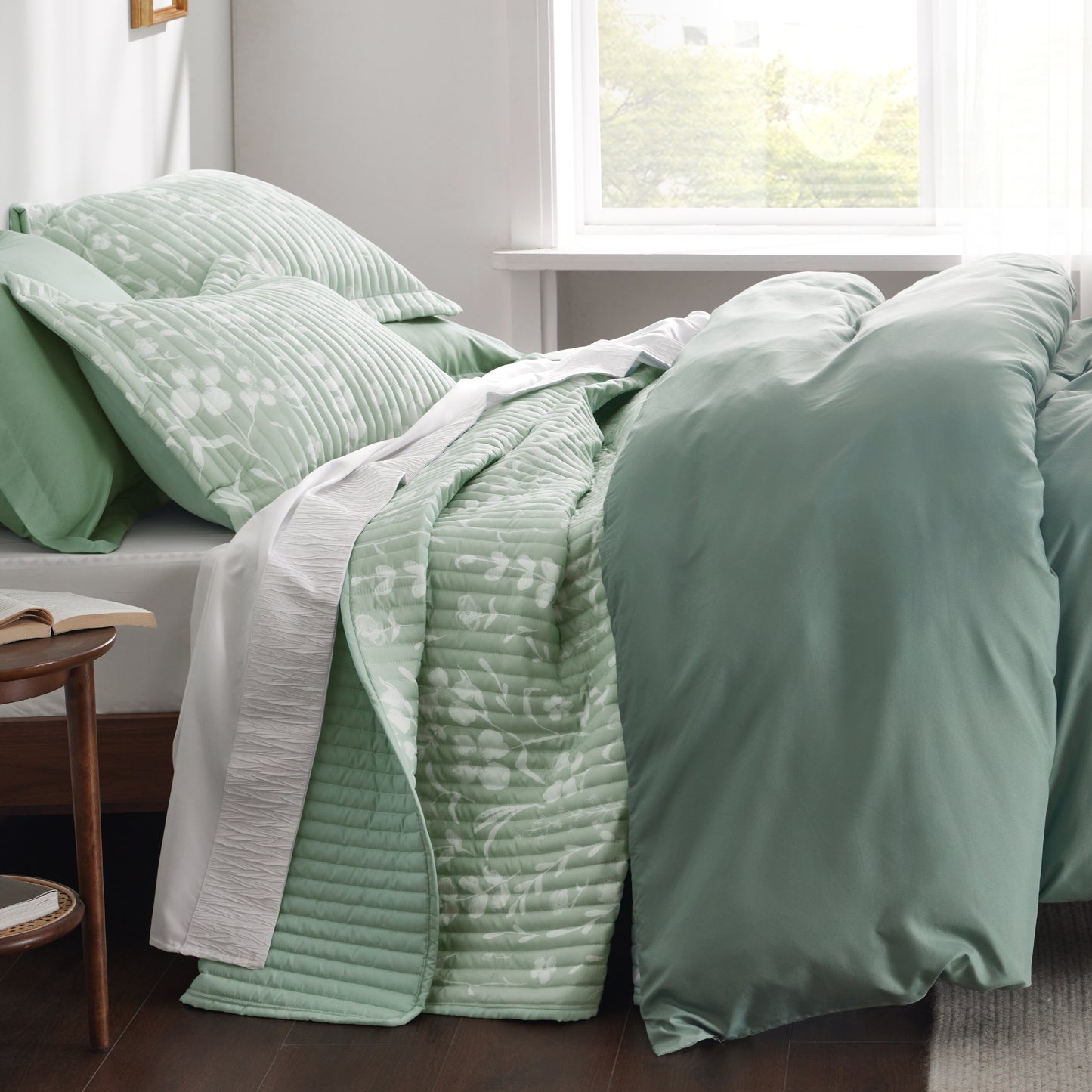 Sage green botanical quilt set with white floral pattern, quilted polyester.