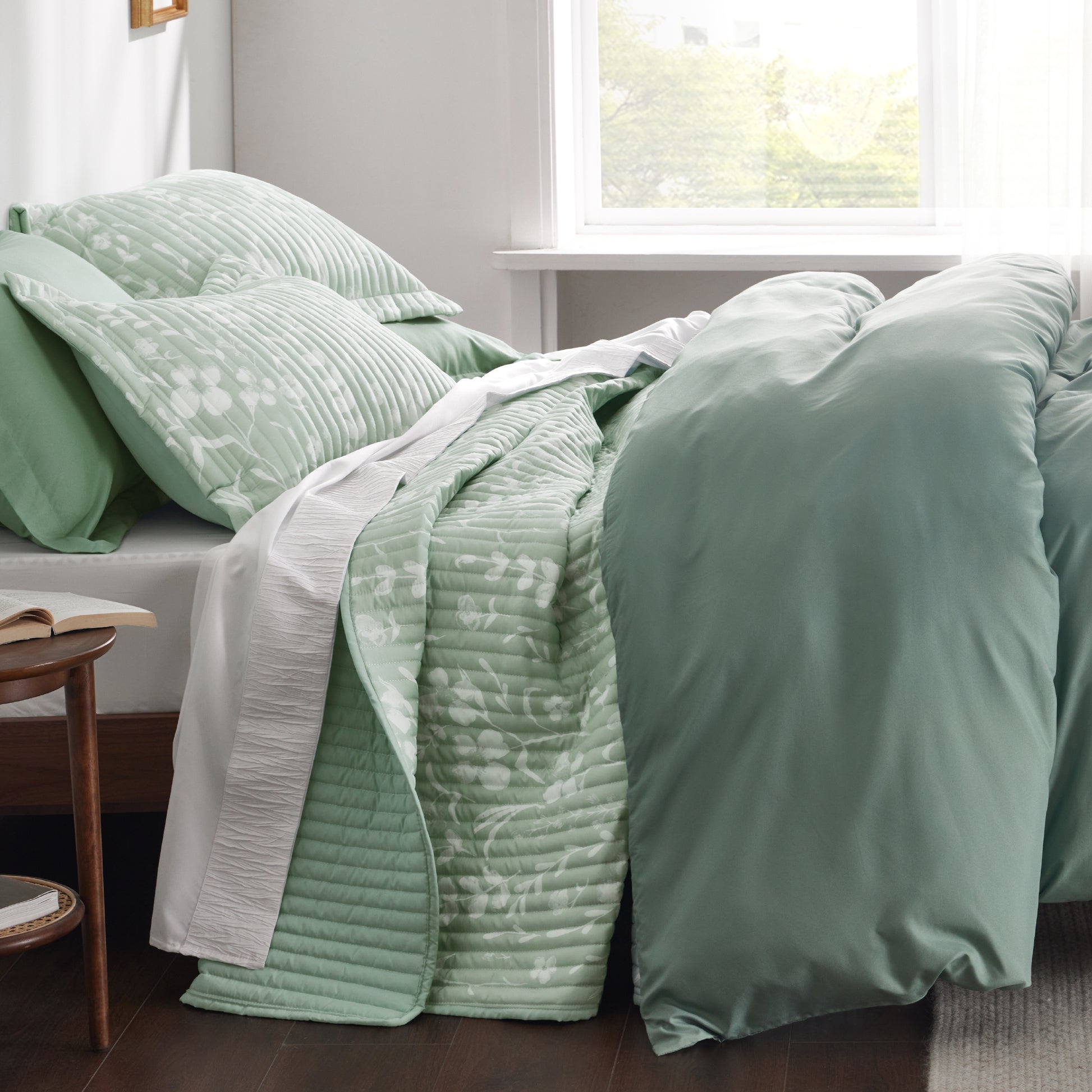 Sage green botanical quilt set with white floral pattern, quilted polyester.
