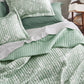 Botanical quilt set in light green with white floral pattern and channel quilting. Polyester.