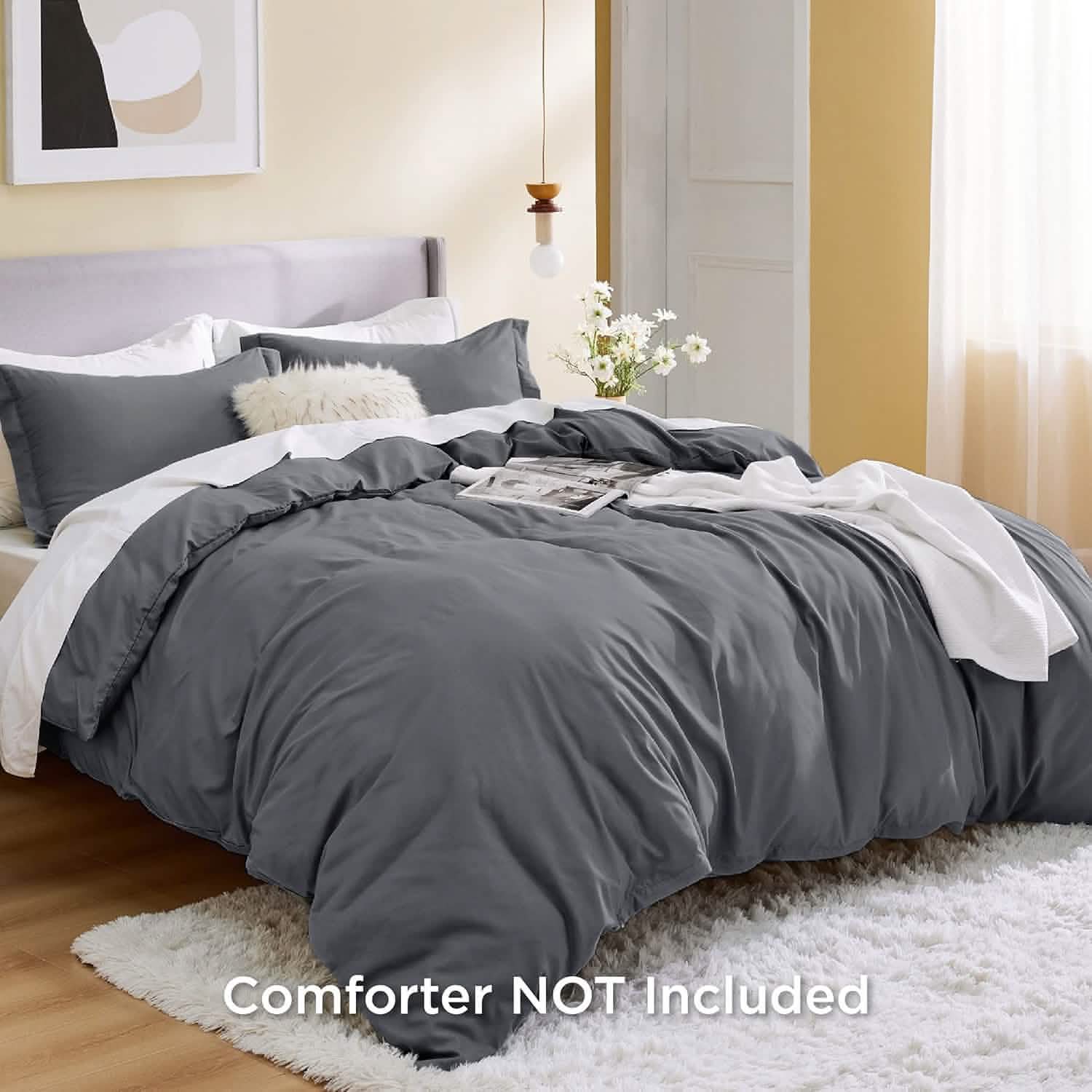 GentleSoft dark gray brushed microfiber duvet cover set with shams on a bed, styled with white sheets and faux fur pillow.