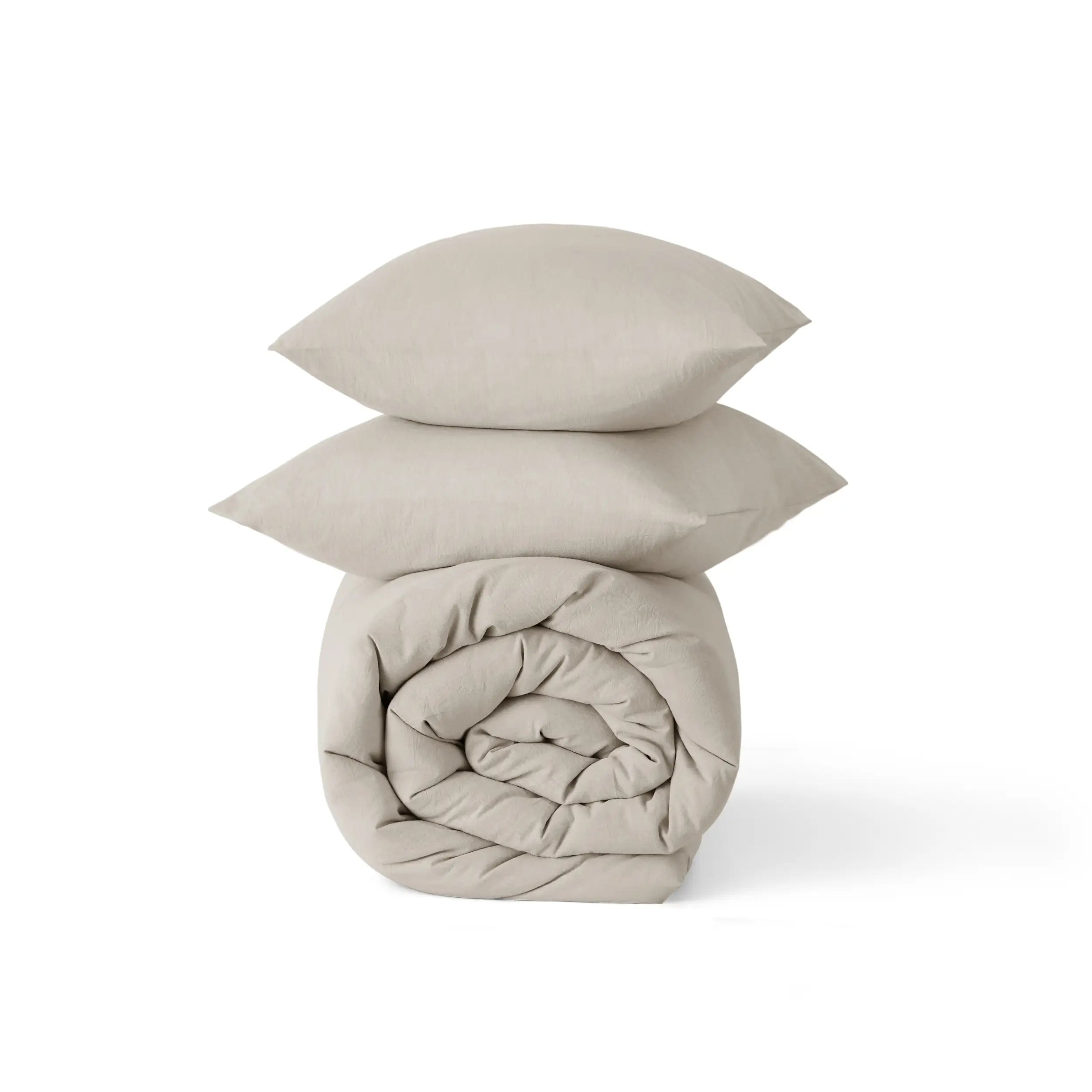 GentleSoft® prewashed cotton comforter set in beige, rolled comforter and two shams with natural wrinkles.