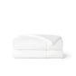 White Nylon Cooling Comforter folded, showcasing soft, smooth texture and quilted design.