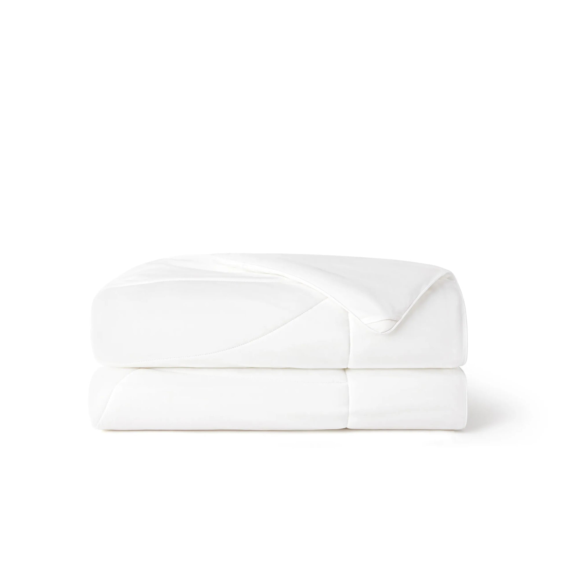 White Nylon Cooling Comforter folded, showcasing soft, smooth texture and quilted design.