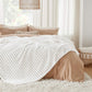 GentleSoft white polyester blanket with ribbed texture draped on a bed. Cozy and soft feel.