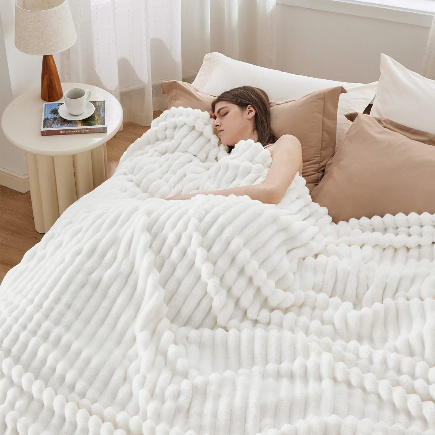 GentleSoft white polyester blanket with plush ribbed texture draped over sleeping woman in cozy bedroom setting.