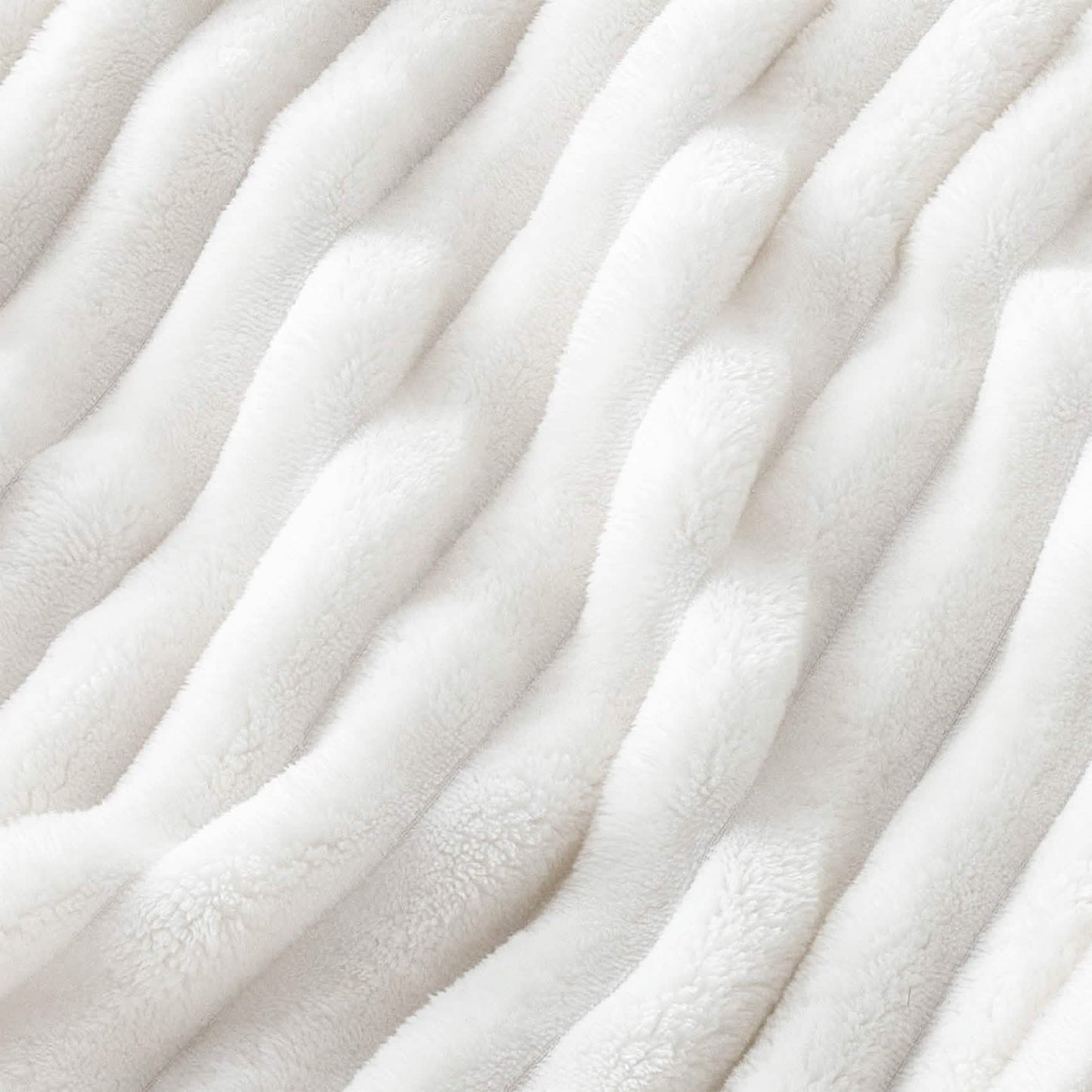 GentleSoft white polyester blanket close-up showing plush ribbed texture, emphasizing softness and material.