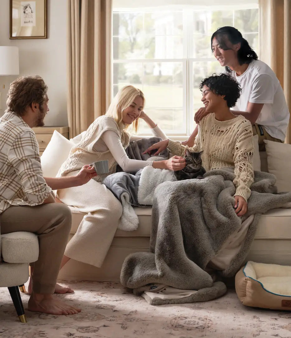 Group of people sitting on a couch in a cozy living room. 