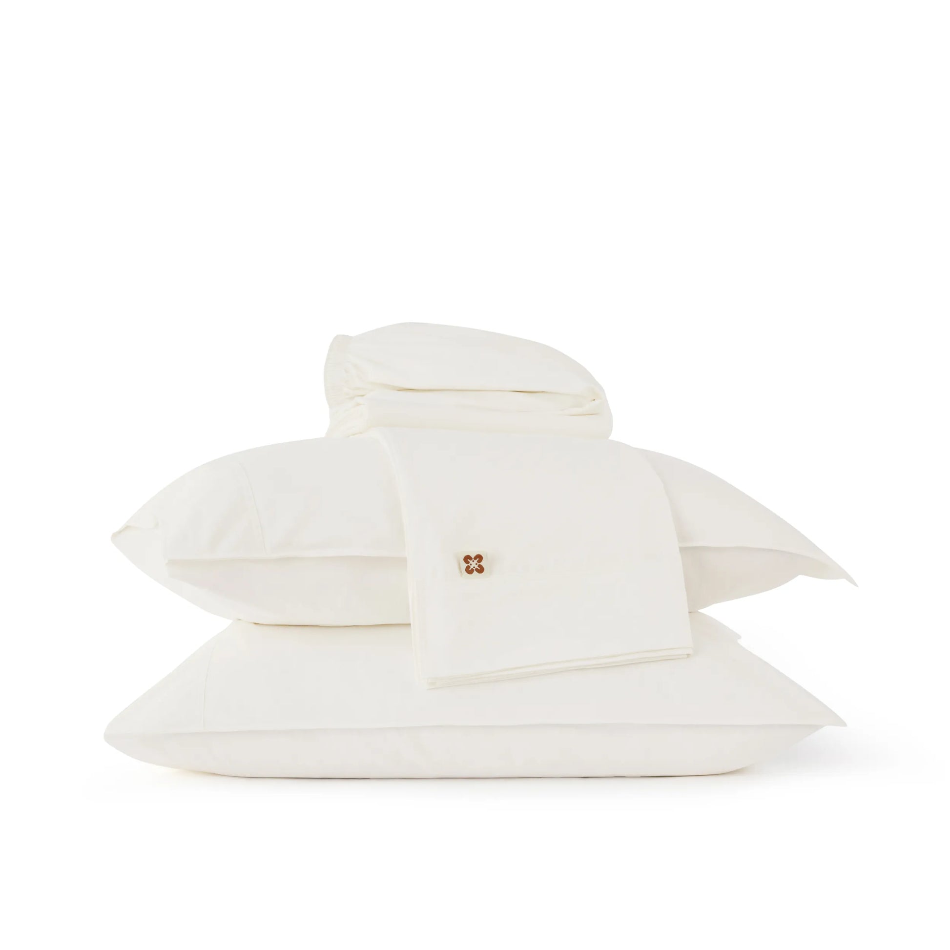 White organic cotton sheet set with a brand logo on a white background